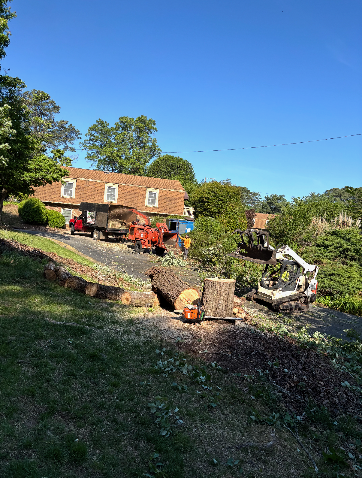Tree crew with chip truck and equipment on a residential removal
